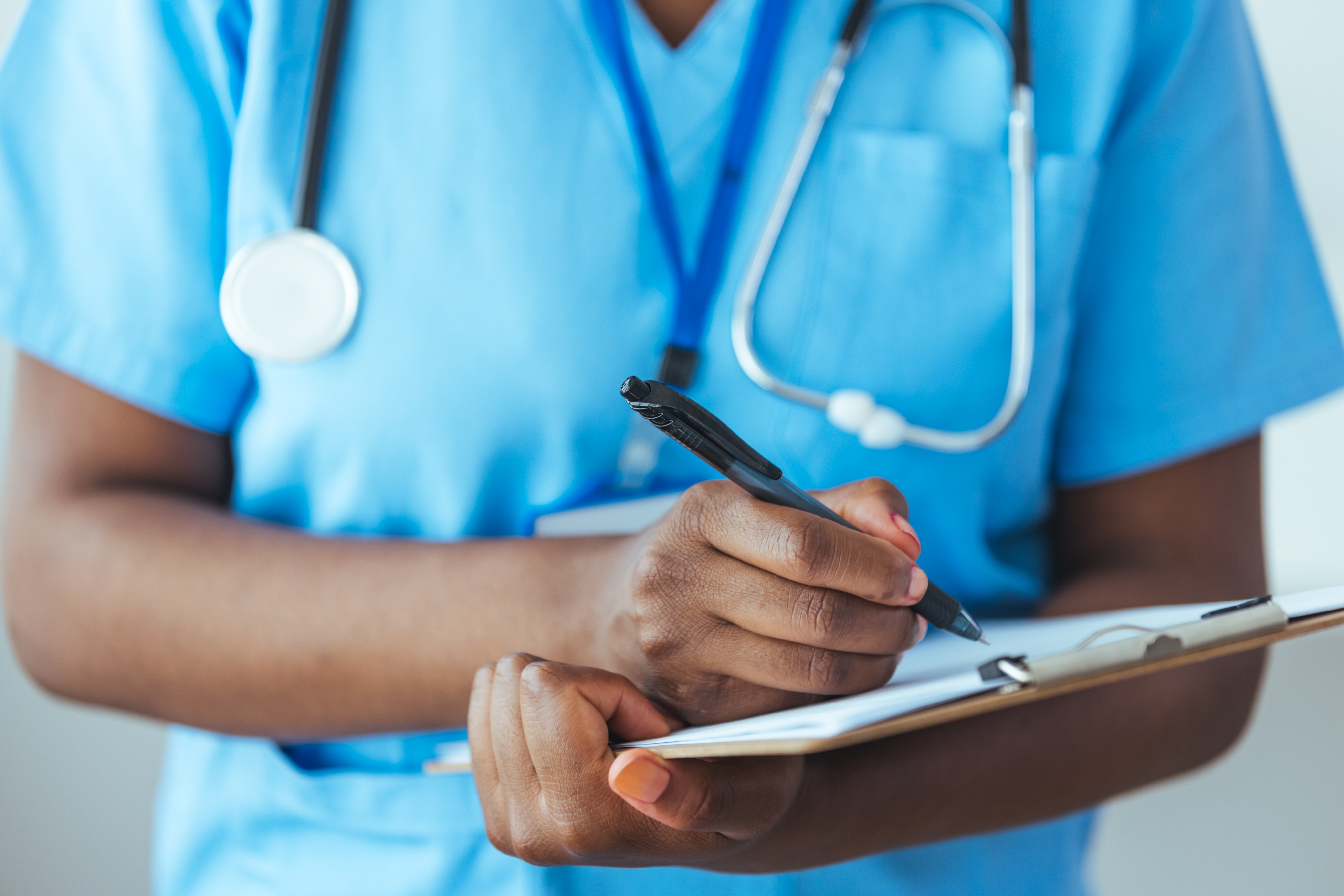 Unrecognizable nurse checking a patients medical chart