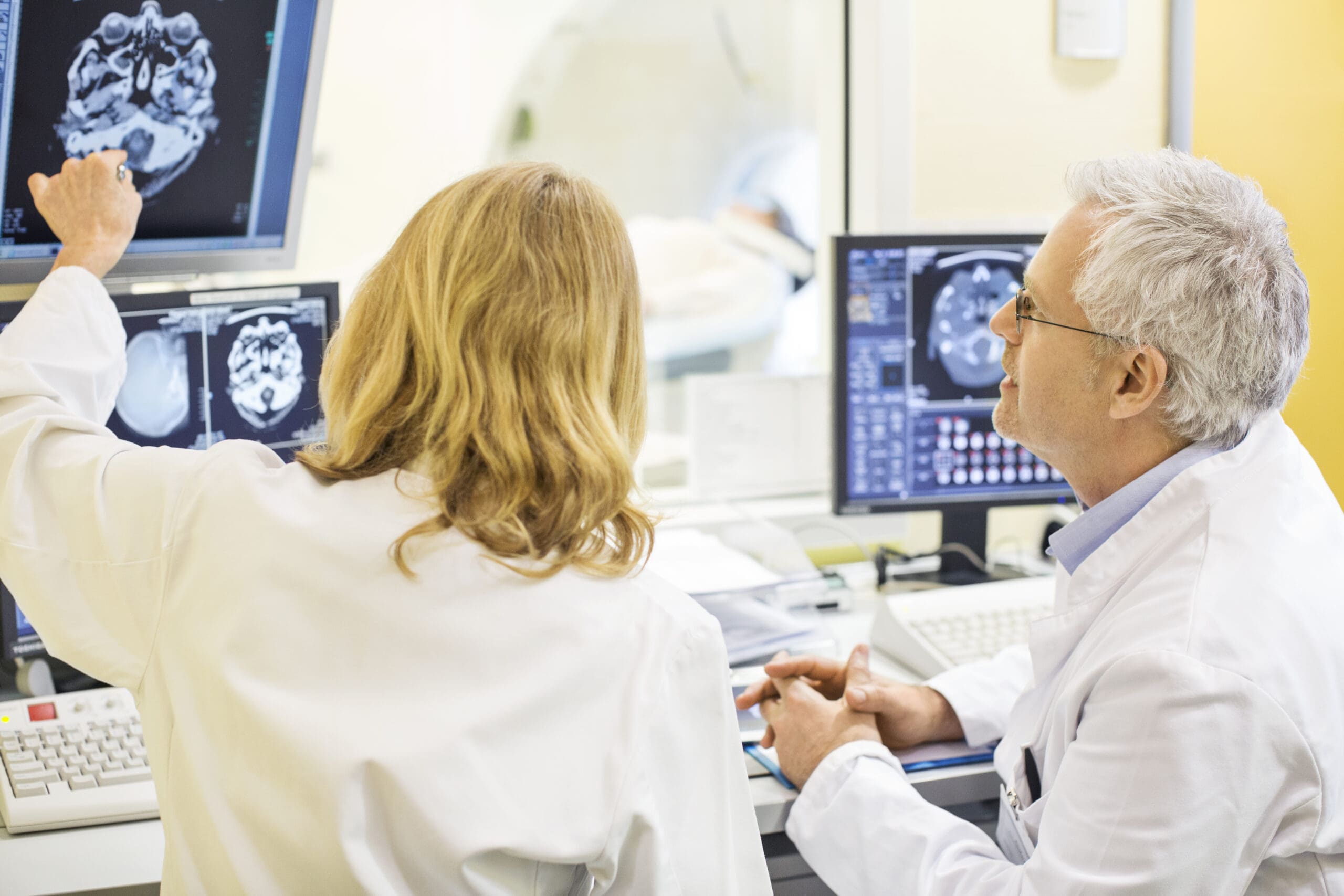 Mature doctors analyzing X-ray image at hospital